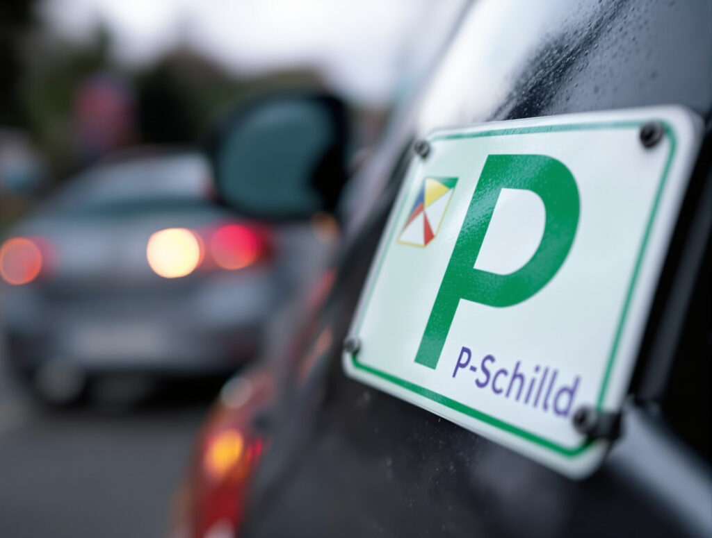 Green probation sign on vehicle rear with blurred background