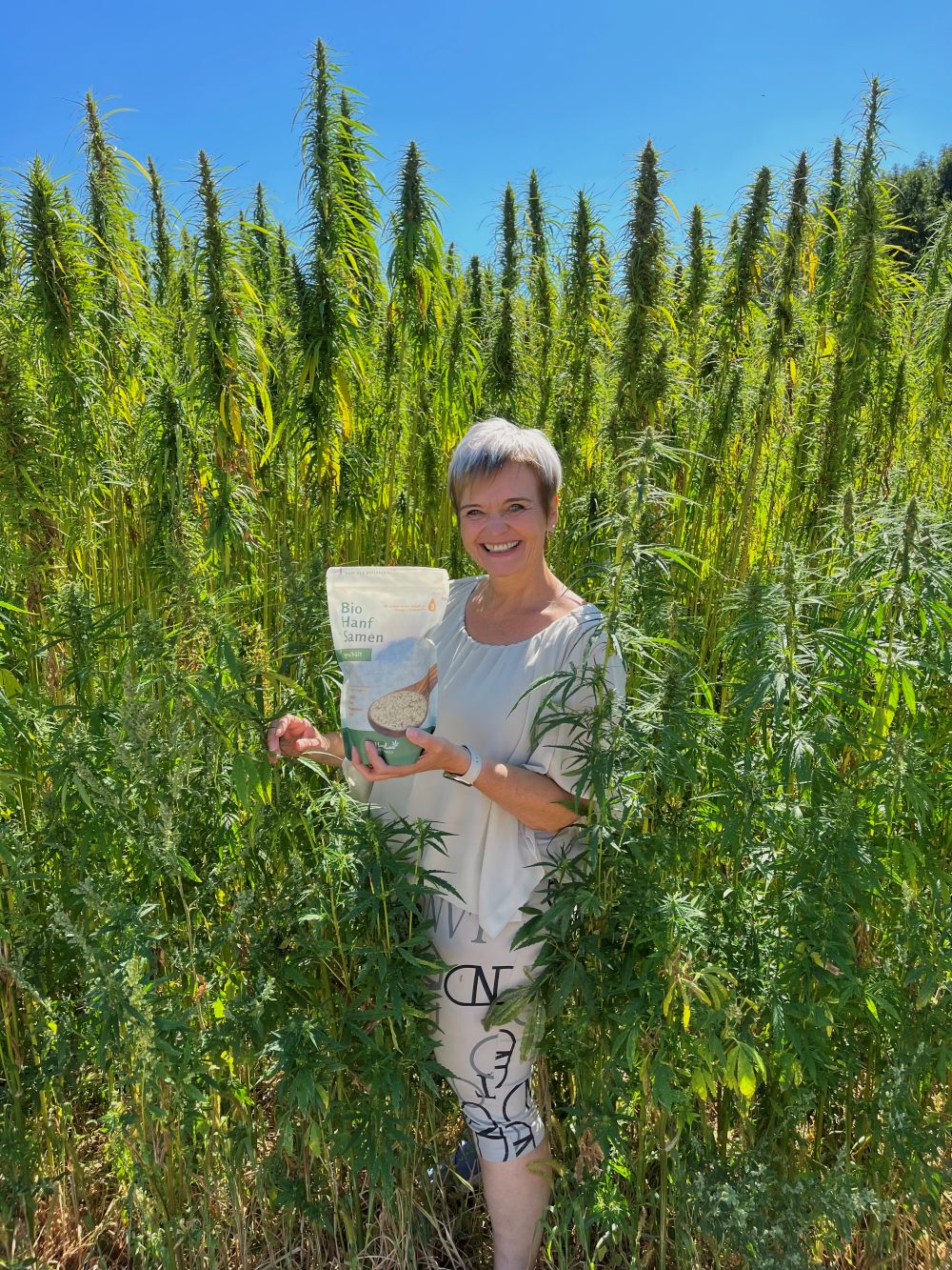 Gerda Steinfellner im Hanffeld mit Hanfsamen