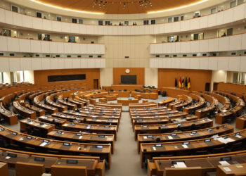 Bundesrat-Plenarsaal mit leeren Delegiertenplätzen in Holz und Creme